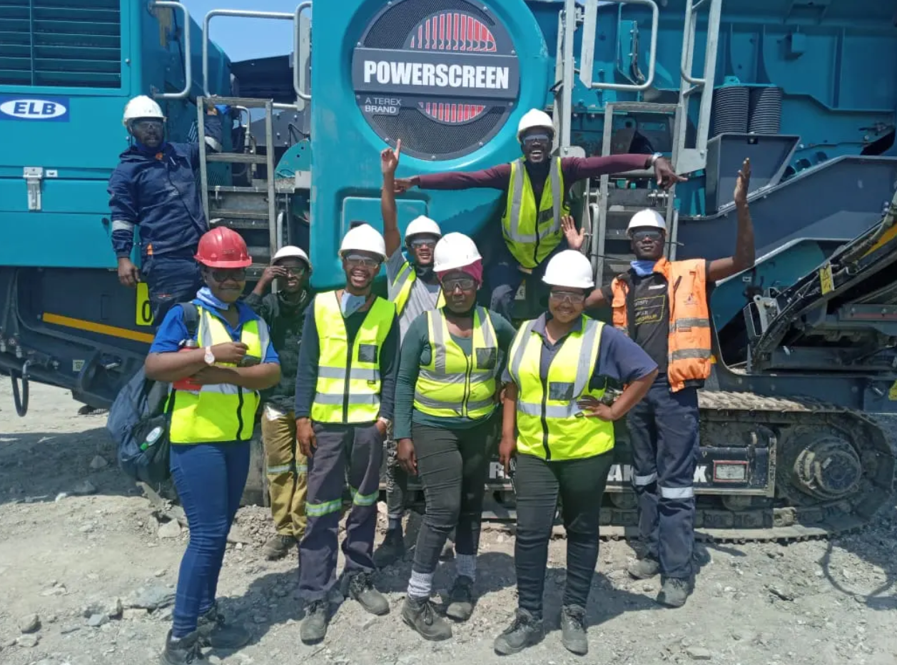 Mphakama operations team in front of crushing machinery